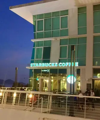 a building with a starbucks coffee sign in front of it at Big BathTub Premium Seafront Studio in Town with WiFi & Full Kitchen in George Town