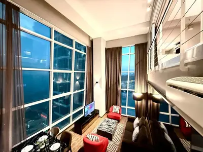 a hotel room with a large window and a room at Seaview Seafront Duplex in Town with WiFi & Full Kitchen 10 in George Town