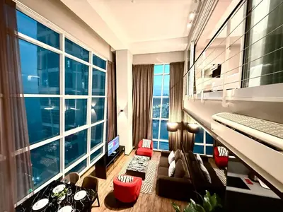 a living room with large windows and a couch at Seaview Seafront Duplex in Town with WiFi & Full Kitchen 10 in George Town