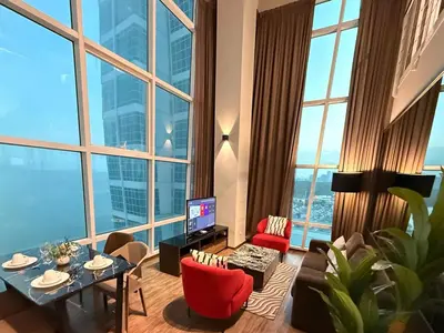 a living room with a table and a large window at Seaview Seafront Duplex in Town with WiFi & Full Kitchen 10 in George Town