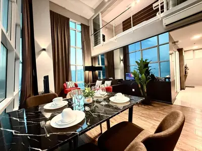 a dining room with a table and chairs in a living room at Seaview Seafront Duplex in Town with WiFi & Full Kitchen 10 in George Town