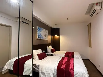two beds in a hotel room with a mirror at Seaview Seafront Duplex in Town with WiFi & Full Kitchen 16 in George Town