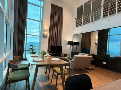 a living room with a table and chairs at Seaview Seafront Duplex in Town with WiFi & Full Kitchen 16 in George Town