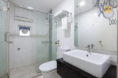 a bathroom with a sink and a toilet and a shower at Seaview Seafront Duplex in Town with WiFi & Full Kitchen 16 in George Town