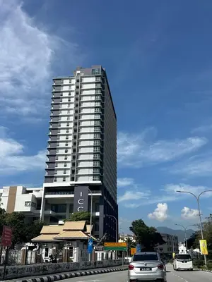 a tall building with cars parked in front of it at ICC Luxury Suites Ipoh City Centre By Landmark in Ipoh