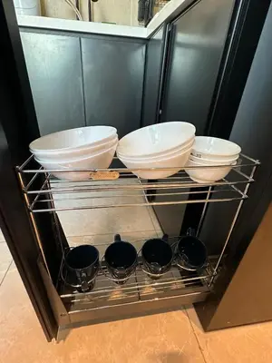 a shelf with bowls and plates on it at ICC Luxury Suites Ipoh City Centre By Landmark in Ipoh