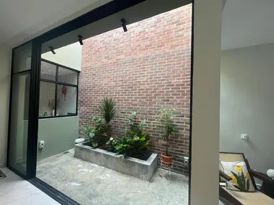a brick wall with potted plants in a room at Brickyard at 6 in Ipoh