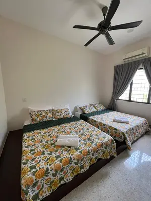 a bedroom with two beds and a ceiling fan at Brickyard at 6 in Ipoh