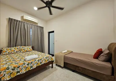 a bedroom with a bed and a ceiling fan at Brickyard at 6 in Ipoh