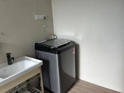 a bathroom with a trash can next to a sink at Brickyard at 6 in Ipoh