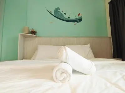 a pile of towels sitting on top of a bed at D'Ocean Marina Laguna Resort by Manhattan Group in Lumut