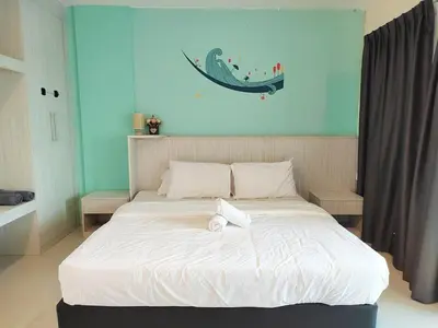 a bedroom with a large white bed with a whale on the wall at D'Ocean Marina Laguna Resort by Manhattan Group in Lumut