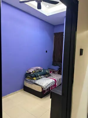 a room with a bed with purple walls and a ceiling at Budget Homestay Lahat in Ipoh