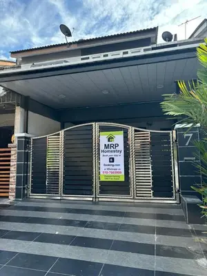 a garage with a sign on the front of a house at Budget Homestay Lahat in Ipoh