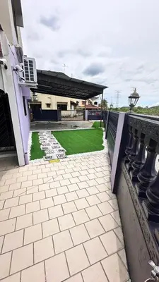 a building with a patio with a green lawn at Raintown House in Taiping