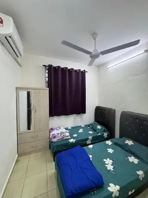 a living room with a bed and a window at Wika Homestay in Lunas