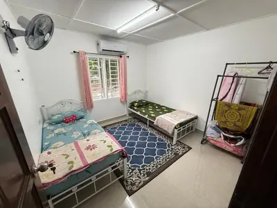 a small room with two beds and a window at Teratak Laman Bari in Sekincan