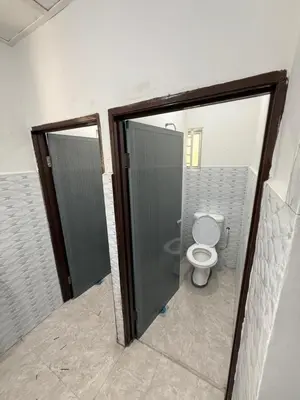 a bathroom with a toilet and a stall with a door at Teratak Laman Bari in Sekincan