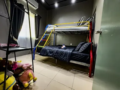 a small room with a bunk bed in it at NDD Homestay in Sitiawan