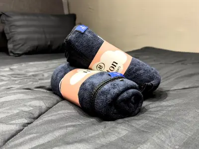 a teddy bear is laying on a bed at NDD Homestay in Sitiawan