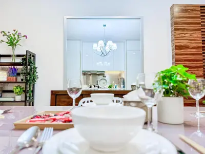 a dining room table with a white bowl and glasses at Georgetown near Gurney and Straits Quay Seaview with Netflix and Washer Dryer in George Town