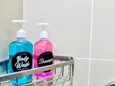 two bottles of soap on a rack in a bathroom at Georgetown near Gurney and Straits Quay Seaview with Netflix and Washer Dryer in George Town