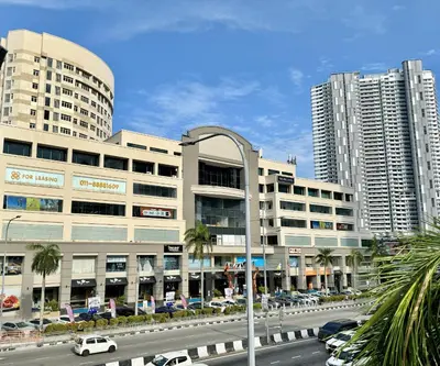 a street with cars parked in front of tall buildings at Georgetown near Gurney and Straits Quay Seaview with Netflix and Washer Dryer in George Town