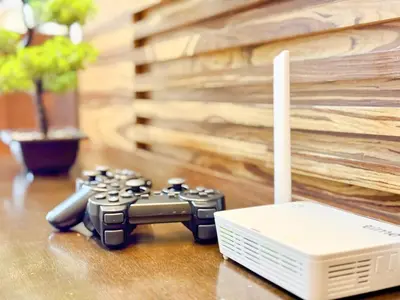 a video game controller and a modem on a table at Georgetown near Gurney and Straits Quay Seaview with Netflix and Washer Dryer in George Town