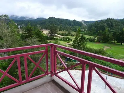 a red bridge with a view of a golf course at Golf View Apartment in Brinchang in Tanah Rata
