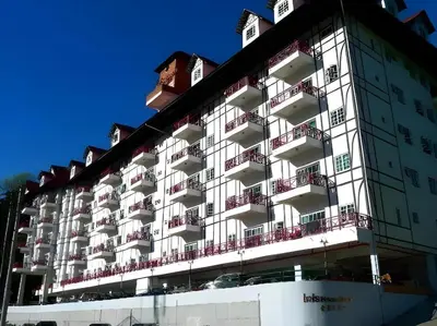 a large white building with balconies on it at Golf View Apartment in Brinchang in Tanah Rata