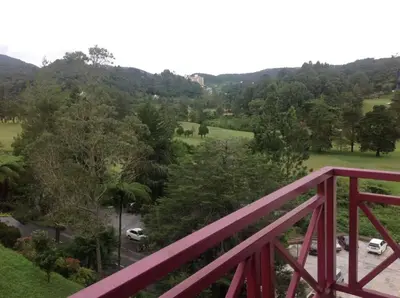 a red bridge with a view of a park at Golf View Apartment in Brinchang in Tanah Rata