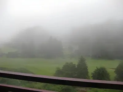 a view of a foggy field from a train window at Golf View Apartment in Brinchang in Tanah Rata