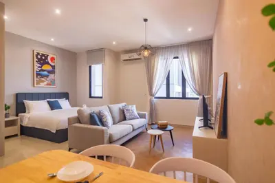 a living room with a bed and a couch and a television at Iconic Regency by Stellar ALV in Bayan Lepas