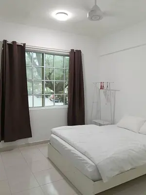 a white bedroom with a bed and a window at Fatty House in Kampar