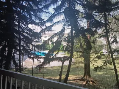 a view of a beach from a balcony with a tree at Fatty House in Kampar