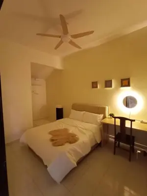 a bedroom with a bed with a ceiling fan at Cheerfull-Cozy Japanese Style in Bukit Mertajam