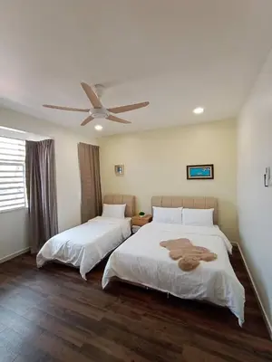 a bedroom with two beds and a ceiling fan at Cheerfull-Cozy Japanese Style in Bukit Mertajam