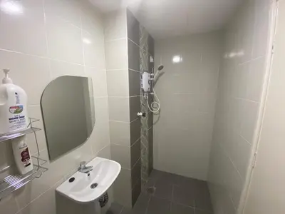 a bathroom with a sink and a shower with a mirror at Anderson Residency Ipoh Wifi Pool Islam in Ipoh