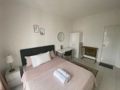 a bedroom with a bed with two towels on it at Anderson Residency Ipoh Wifi Pool Islam in Ipoh