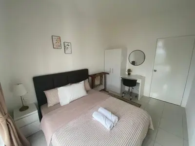 a bedroom with a bed with two pillows on it at Anderson Residency Ipoh Wifi Pool Islam in Ipoh
