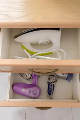 a wooden shelf with various items in a drawer at Eastern Apt, Jelutong in Jelutong