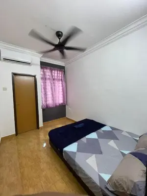 a bedroom with a bed and a ceiling fan at Bayan Homestay Bayan Lepas Penang in Bayan Lepas