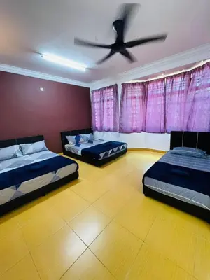 two beds in a room with a ceiling fan at Bayan Homestay Bayan Lepas Penang in Bayan Lepas