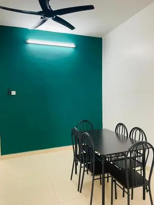 a dining room with a black table and chairs at Bayan Homestay Bayan Lepas Penang in Bayan Lepas