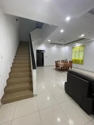 a living room with a staircase and a dining room at 6 Rooms Budget 3 Tingkat USM Gelugor Georgetown in Gelugor