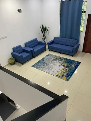 a lobby with two blue couches and a table at 6 Rooms Budget 3 Tingkat USM Gelugor Georgetown in Gelugor