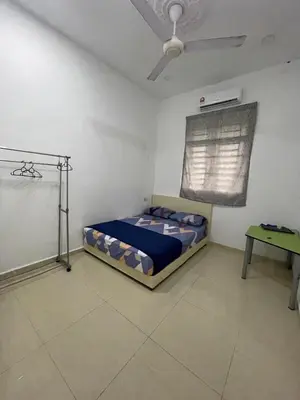 a bedroom with a bed and a table in it at 6 Rooms Budget 3 Tingkat USM Gelugor Georgetown in Gelugor