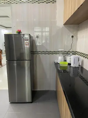 a kitchen with a stainless steel refrigerator on a counter at 6 Rooms Budget 3 Tingkat USM Gelugor Georgetown in Gelugor