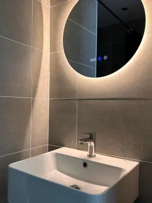 a white sink in a bathroom with a mirror at IPOH City Centre ICC Suites by HWC in Ipoh