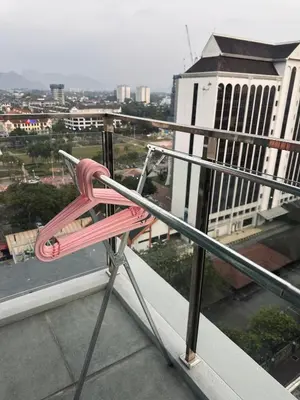 a pink chair sitting on top of a balcony at IPOH City Centre ICC Suites by HWC in Ipoh